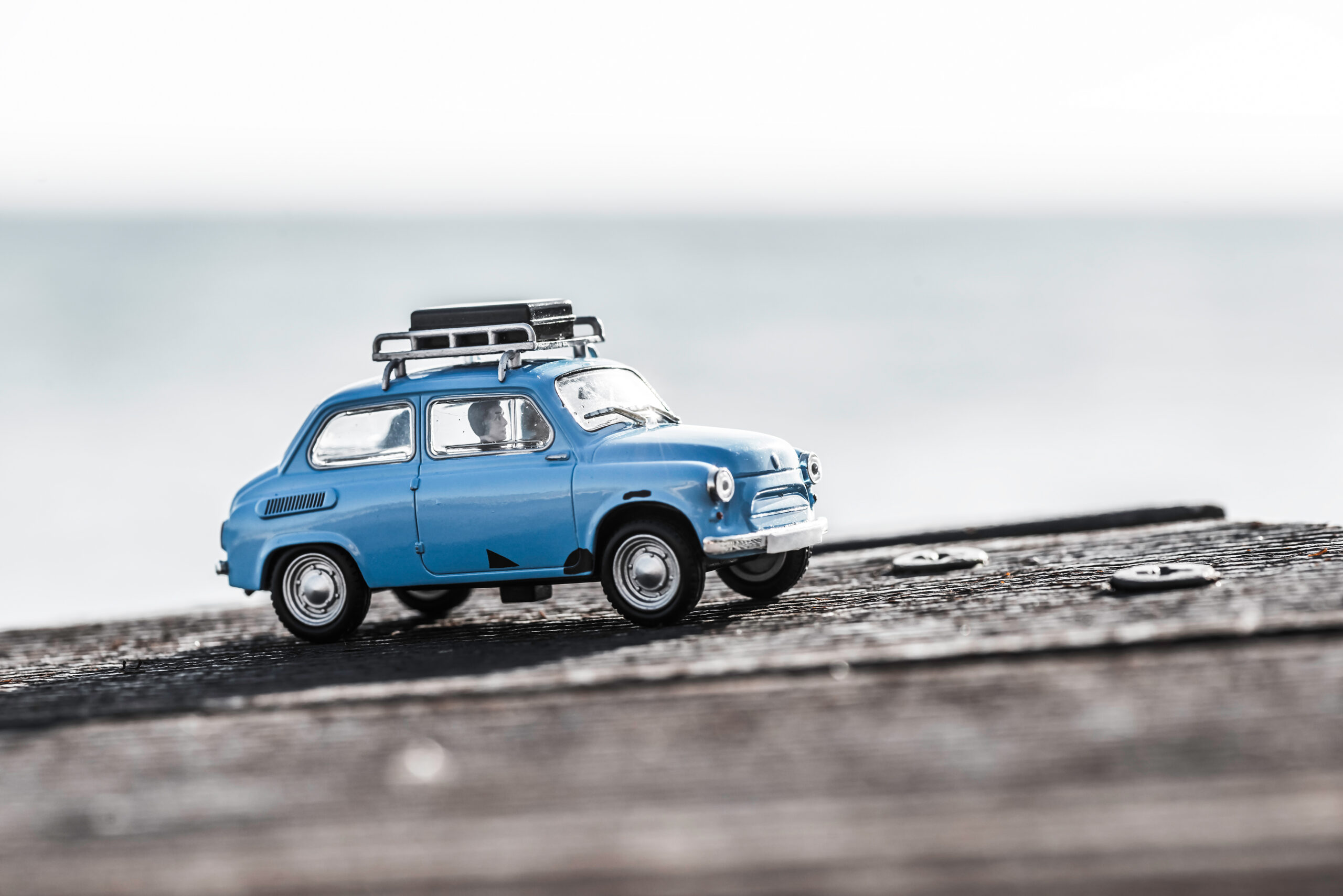 Cute blue retro travel car with luggage. Macro photo